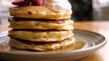 stack of pancakes with strawberries and ice cream pour with honey video
