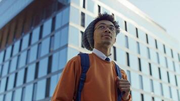 Confident student walking on modern campus video