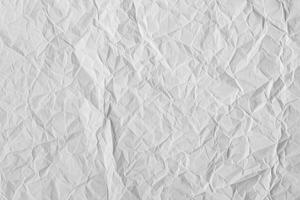 Crumpled white paper texture showcasing intricate patterns and details for design purposes photo