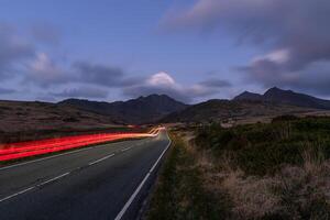 Long Exposure of Car Lights on Scenic Mountain Road photo