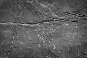 Textured Gray Stone Surface with Natural Cracks and Lines for Background or Design Elements photo