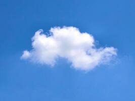 Fluffy White Cloud Against a Clear Blue Sky on a Sunny Day Capturing the Essence of Tranquility and Simplicity in Nature photo
