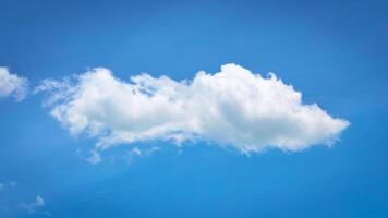 Fluffy White Cloud Against a Vibrant Blue Sky on a Clear Sunny Day Capturing the Essence of Tranquility and Freedom photo