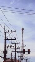 Urban Power Lines and Communication Tower Against a Clear Sky in a Cityscape Setting photo