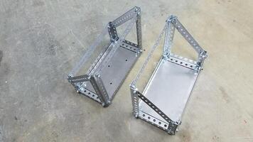 Top View of Two Custom Metal Gas Can Holders Made from Steel Perforated Angle photo