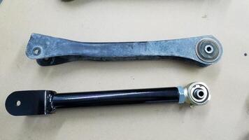 Old and New Control Arms for a 4x4 Vehicle, New one is Adjustable photo