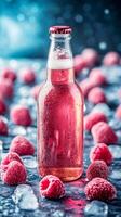 Chilled raspberry beer bottle with condensation and berries on slate. Refreshing summer drink with copy space photo