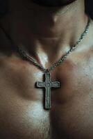 Christian pectoral cross on thin cord resting on chest of believer during quiet reflection photo