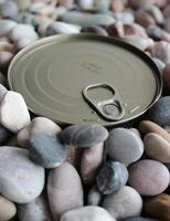 The top lid of the long term can with the key is buried in small pebbles photo