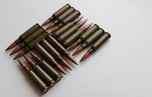 Geometric pattern of ammunition cartridges on a white background on the left side of the image photo