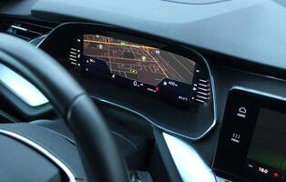 Navigation display on instrument cluster showing the car position on city map top view photo