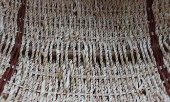The bottom of a round craft basket woven from braided willow twigs photo