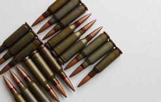 Live cartridges are laid out in a strict geometric shape on white backdrop studio isolated photo