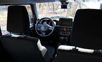 View From Rear Seats On A Dashboard And Front Panel Inside Off Road Car With Dirty Windshield photo