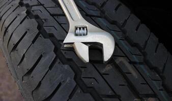 12 Inch Adjustable Spanner On A New Tire Close Up Angle View photo