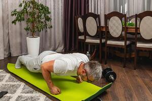 Man doing push-ups at home during workout session photo