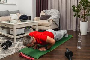 Man doing push-ups in home gym setting photo