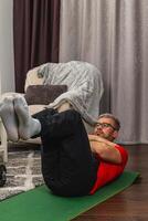 Man working out at home during the afternoon photo
