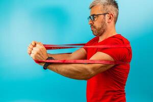 Man exercises with resistance bands at home studio photo