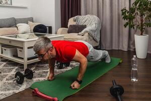 Man doing push-ups at home gym in casual attire photo