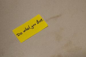Message on a yellow note encouraging passion and dedication to dreams photo