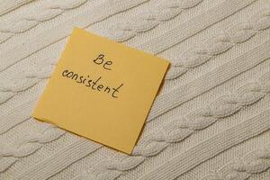 Reminder note on a textured surface encourages consistent habits in daily life photo