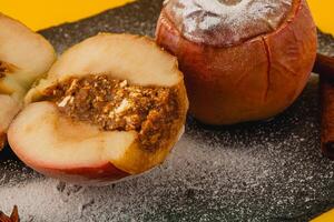 Baked apples with caramel filling on slate plate photo