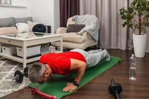 Man exercising at home during workout session photo
