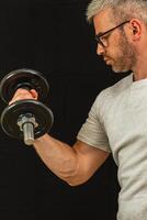 Man lifting dumbbell in workout session at home gym photo
