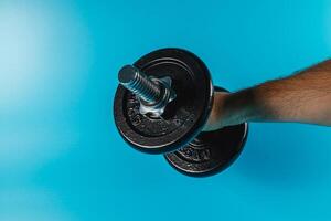 Weightlifting session with a black dumbbell in focus photo