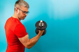 Fitness enthusiast lifting dumbbell in home gym setting photo