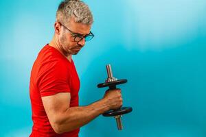 Exercising with dumbbell in a bright gym setting photo