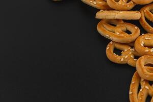 Delicious pretzels scattered on a dark surface ready for snacking at any time photo