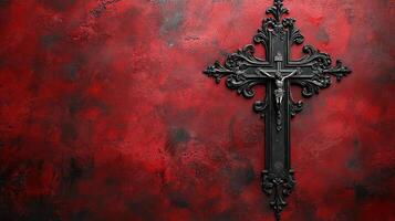 Dark ornate cross with figure of Christ hangs on textured red wall evoking dramatic world of faith and day of reflection with hint of dracula photo