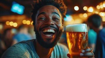 Joyful man laughing with bright eyes holding glass of golden beer in lively bar with warm lights and blurred background photo