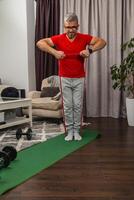 Older man exercising with resistance bands at home photo