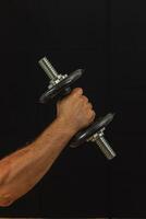 Strength training with a dumbbell in a gym setting photo