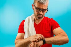 Man checking smartwatch during workout in gym photo