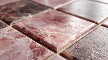 Marble tile surface with pink and brown tones showing natural stone texture and veins in close up view creating warm and elegant atmosphere photo