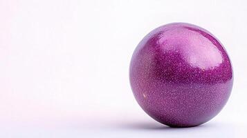A purple egg sitting on a white surface photo