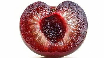 A plum is cut in half on a white background photo