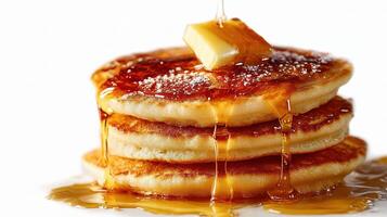 A stack of pancakes with syrup and butter photo
