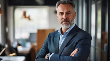 A man with a beard and suit standing in an office photo
