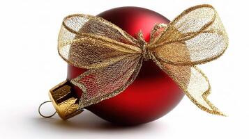 A red christmas ball with a gold bow photo