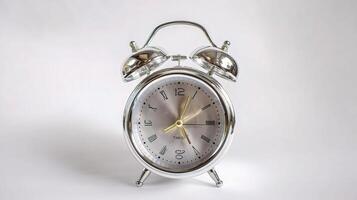 An alarm clock is shown on a white background photo