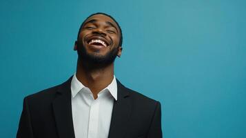 A man in a suit laughing and smiling photo