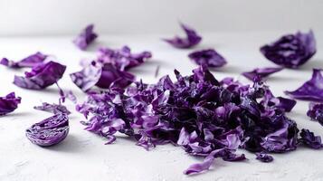 Purple cabbage leaves scattered on a white surface photo