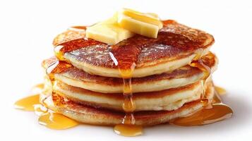 A stack of pancakes with butter and syrup photo