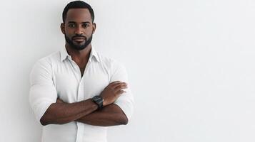 A man in a white shirt standing with his arms crossed photo