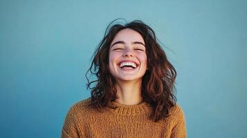 A woman laughing with her eyes closed photo